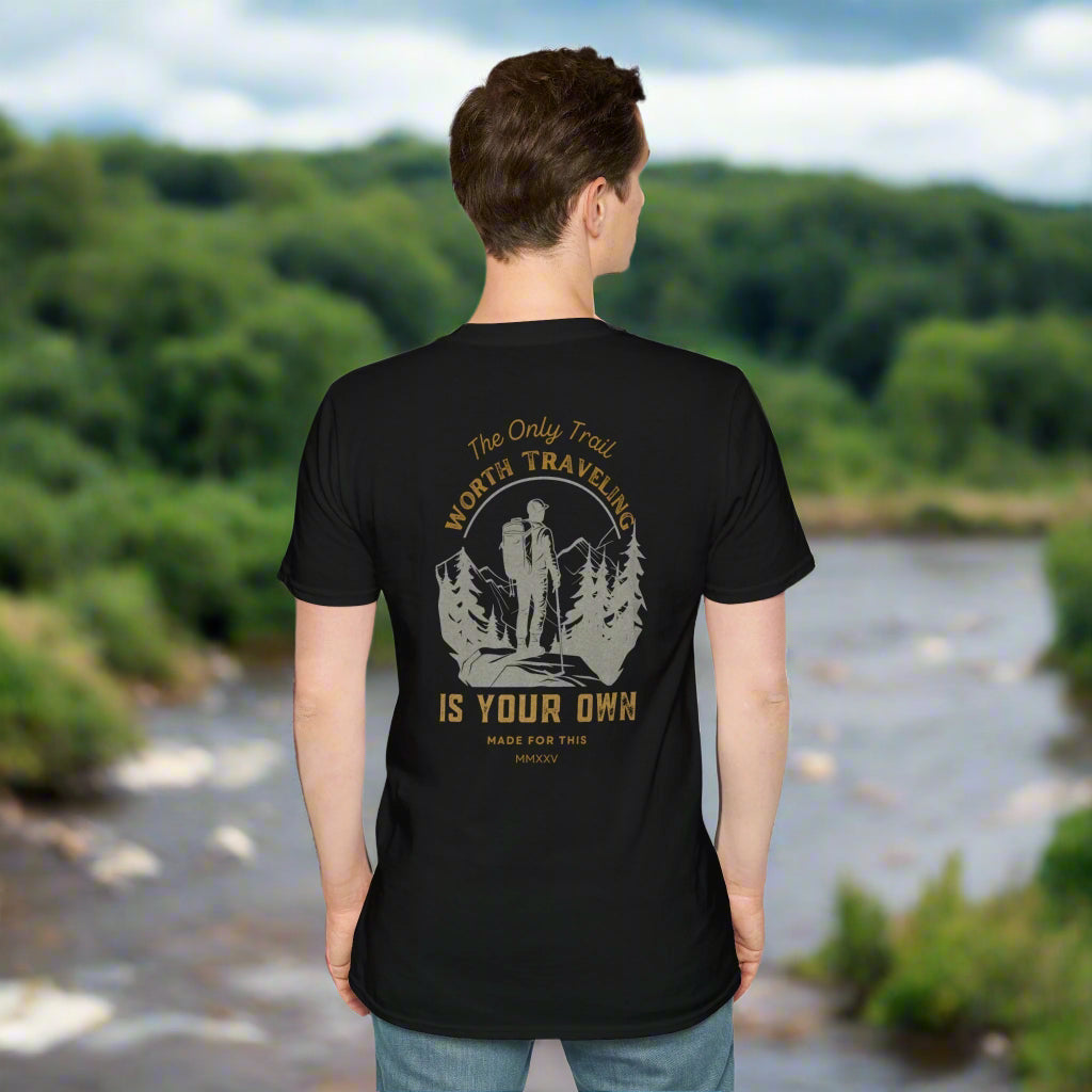 Person wearing a black t-shirt with a graphic and text on the back, standing against a white background